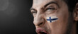 © butenkow - A screaming man with the image of the Finland national flag on his face