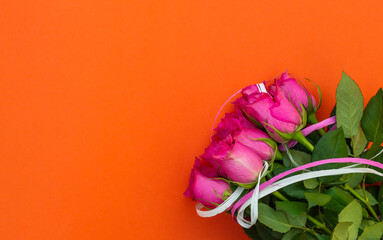 Wall Mural - Bouquet of pink roses on bright orange background. Top view. Space for text.