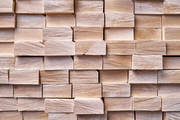 Large stack of new boards of natural solid birch for table legs production in contemporary carpentry warehouse close view