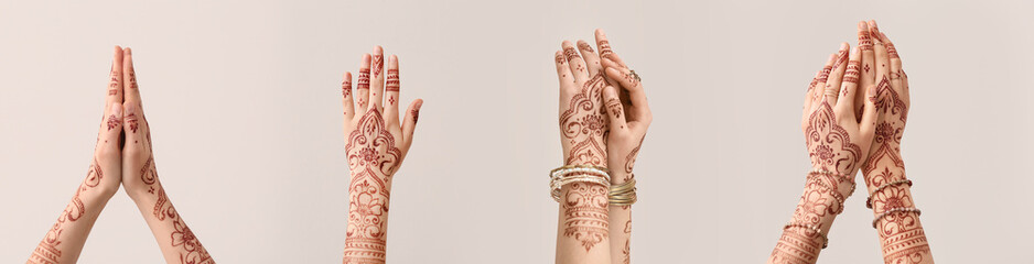 Wall Mural - Beautiful female hands with henna tattoo on light background