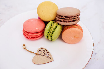 Beautiful variety of macaroons on marble background. Stylish arrangement sweet. Flat lay, top view. 