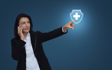 Wall Mural - Caucasian businesswoman talking on her cell phone and pointing finger to cross shape with shield flat icon over gradient light blue background, Business healthy and medical care insurance online conce