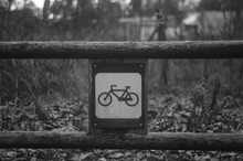 Close-up Of Bike Sign On Railing