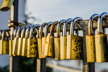 Petrovaradin, Serbia - February 05. 2021: Petrovaradin fortress; Padlocks of love on the fence