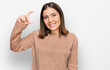 © Krakenimages.com - Young beautiful woman wearing casual clothes smiling and confident gesturing with hand doing small size sign with fingers looking and the camera. measure concept.