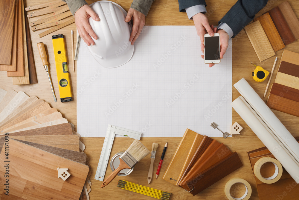 Businessman and construction engineer working at desk - obrazy, fototapety, plakaty 