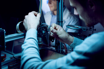 young engineer working on a 3d printer