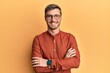 © Krakenimages.com - Handsome caucasian man wearing casual clothes and glasses happy face smiling with crossed arms looking at the camera. positive person.