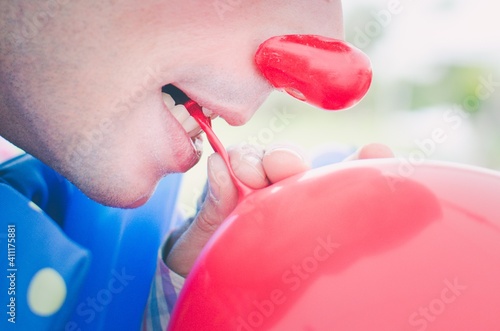 Close-up Of Man Blowing Balloon