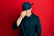 © Krakenimages.com - Handsome young man wearing professional cook uniform and hat tired rubbing nose and eyes feeling fatigue and headache. stress and frustration concept.