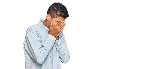 Wall Mural - Young handsome african american man wearing casual clothes with sad expression covering face with hands while crying. depression concept.