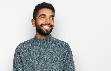 Poster - Young african american man wearing casual clothes looking away to side with smile on face, natural expression. laughing confident.