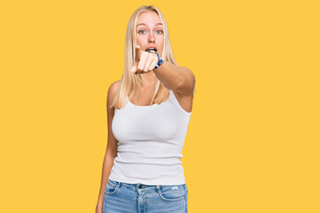 Sticker - Young blonde girl wearing casual style with sleeveless shirt pointing displeased and frustrated to the camera, angry and furious with you