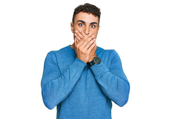 Hispanic young man wearing casual clothes shocked covering mouth with hands for mistake. secret concept.