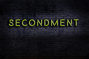 Wall Mural - Neon sign. Word secondment against brick wall. Night view