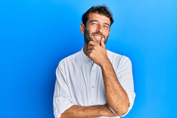 Poster - Handsome man with beard wearing elegant shirt smiling looking confident at the camera with crossed arms and hand on chin. thinking positive.