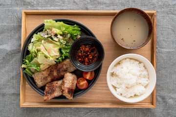 Vietnamese Deep-Fried Spring Rolls served with salad and soup for meal.