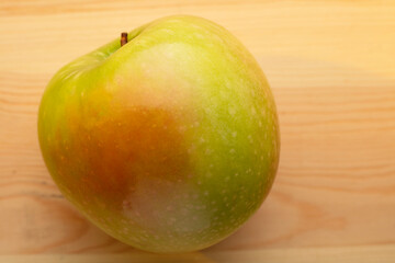 Signle green apple on a wooden background