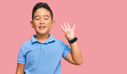 Sticker - Little boy hispanic kid wearing casual clothes showing and pointing up with fingers number four while smiling confident and happy.