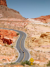 Motorcycle Riding In Valley Of Fire State Parkt On Empty Highway In Scenic Landscape