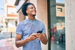 © Krakenimages.com - Young african american man smiling happy using smartphone at the city.