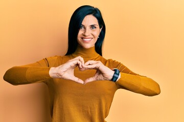 Young caucasian woman wearing casual clothes smiling in love doing heart symbol shape with hands. romantic concept.