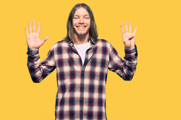 Sticker - Handsome caucasian man with long hair wearing hipster shirt showing and pointing up with fingers number nine while smiling confident and happy.