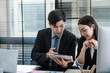 © amnaj - Meeting and discussion ideas of Asian businessman and businesswoman using table at the office.