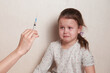 a frightened child is afraid of an injection