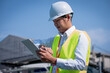 © ART STOCK CREATIVE - Portrait asian manager engineer in hardhat at work on outside industrial,using digital tablet control work and survey building construction factory site,concept action business working and industry.