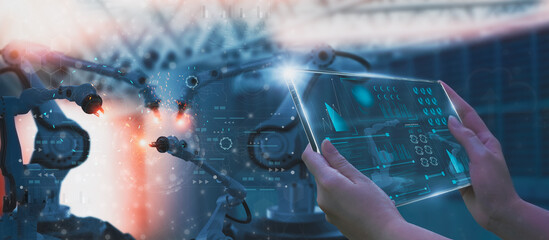 Wall Mural - industry engineer in factory,using smart tablet glass device,control automated robot arm machine lea