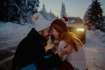 Canvas Print - Beautiful couple sitting on the ground wearing warm clothes for winter with their foreheads pressed