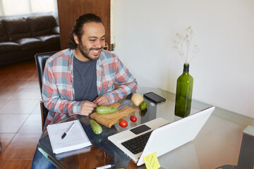 Young mature man taking cooking classes online