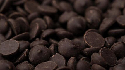 Wall Mural - dark chocolate chips close up rotation. confectionery concept