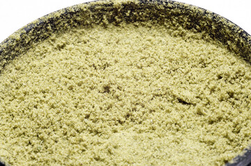 weed grinder full of hemp trichomes of dry medical marijuana flower buds macro image