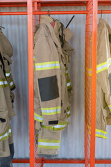 Canvas Print - Firefighter uniforms at station vertical photo