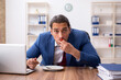 © Elnur - Young businessman working in the office