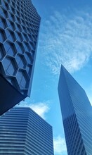 Low Angle View Of Modern Buildings Against Blue Sky