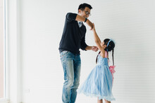 An Asian Father And Daughter Are Dancing, Dad Teaches Daughters To Dance In A Fun Room