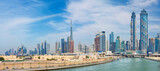 Fototapeta Miasto - Dubai - The skyline with the bridge over the new Canal and Downtown.