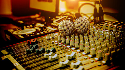 Close-up microphones and audio mixer in studio for sound control system and recording equipment and music instrument.