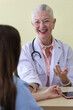 © Bangkok Click Studio - Senior older female doctor taking, explaining and history taking with a patient with a smiley face and intimate manner
