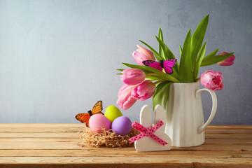 Wall Mural - Easter holiday concept with easter eggs and tulip flowers on wooden table