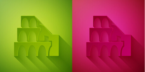 Sticker - Paper cut Coliseum in Rome, Italy icon isolated on green and pink background. Colosseum sign. Symbol of Ancient Rome, gladiator fights. Paper art style. Vector.