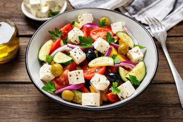 Wall Mural - Classic Greek salad with fresh vegetables, feta cheese and  olives. Healthy food.