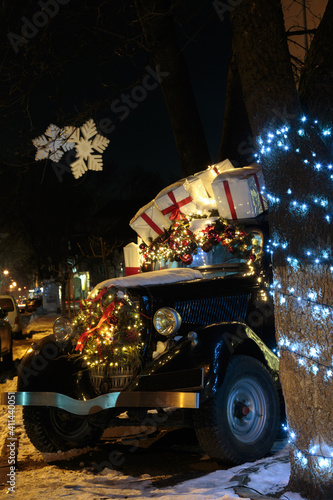 Light and gifts for the christmas on retro car. © indigolotos