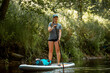 © True Pixel Art - Woman rowing with SUP stand up paddle board in river. Front view
