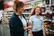 © Jacob Lund - Supermarket manager training young woman worker