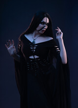 Young Woman In Black Dress In Gothic Style