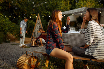 Wall Mural - young friends relax on picnic at camping
